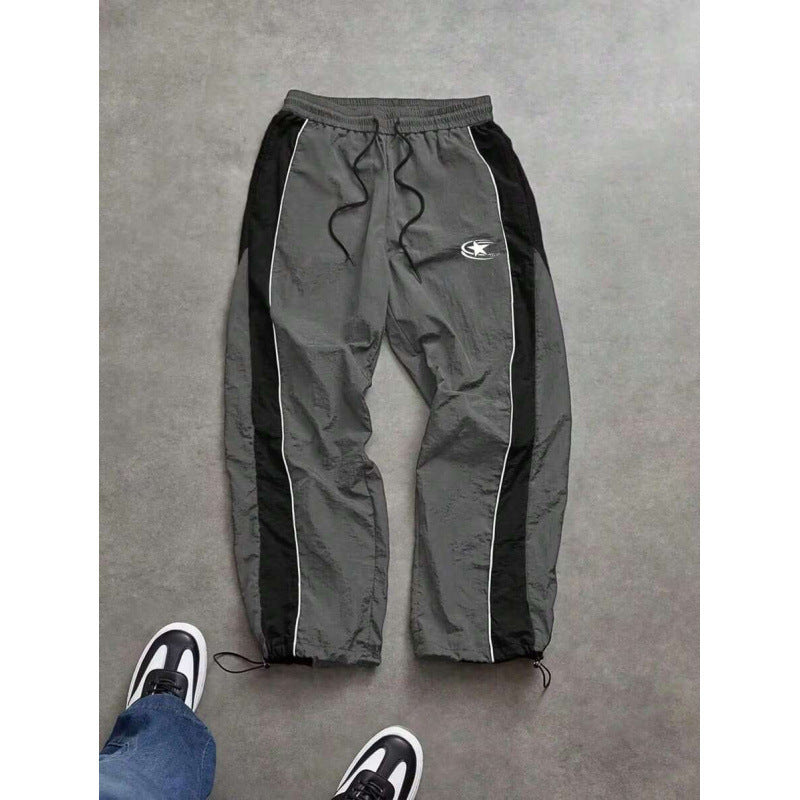 Men's spliced color-blocking printed casual pants with drawstring cuffs and loose straight-leg trousers